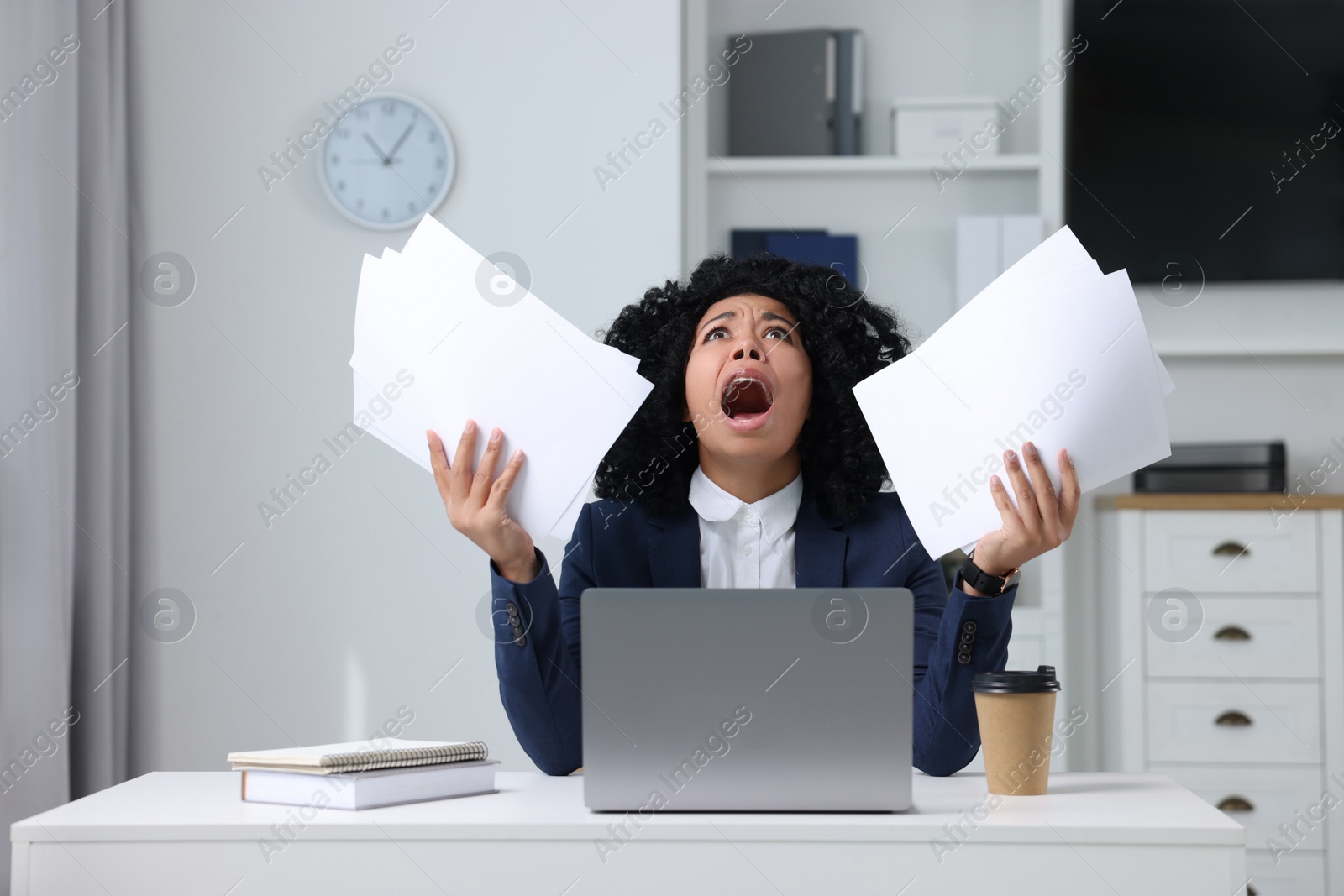 Photo of Deadline concept. Scared woman holding documents and shouting in office