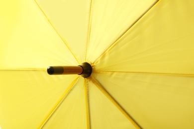 Image of Bright yellow umbrella as background, closeup view