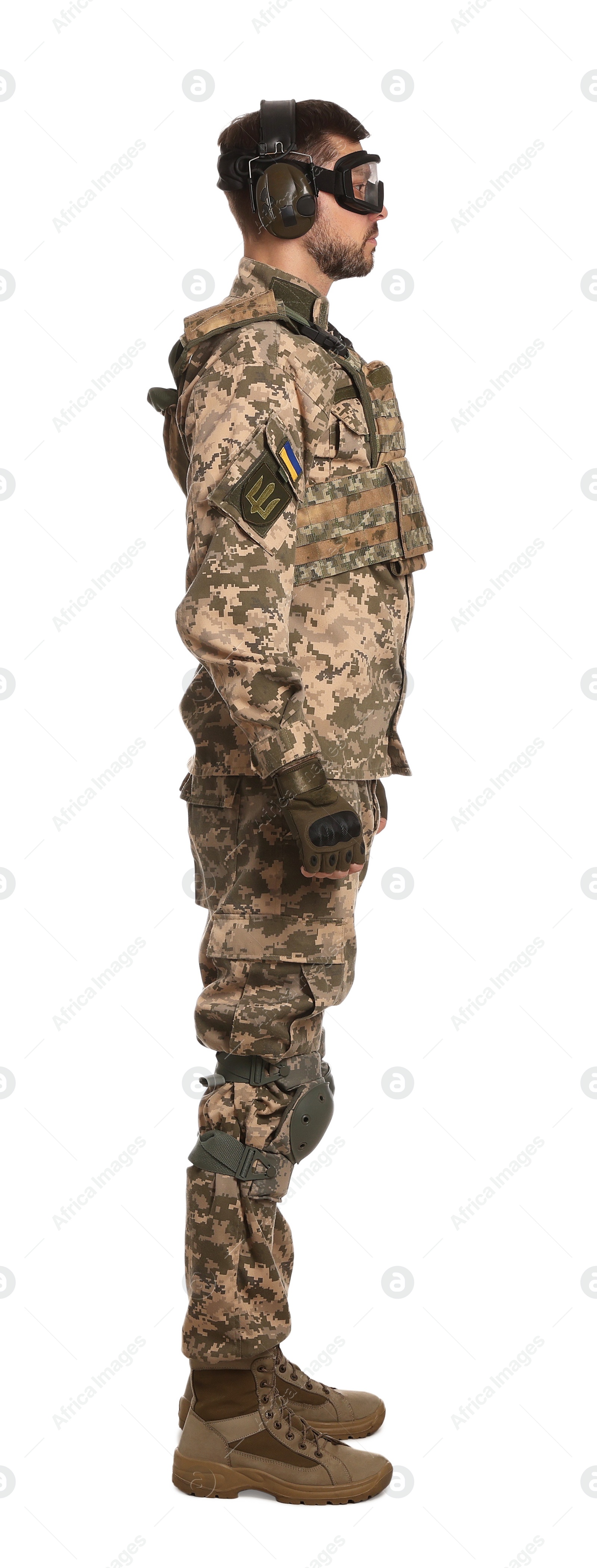 Photo of Soldier in Ukrainian military uniform, tactical goggles and headphones on white background