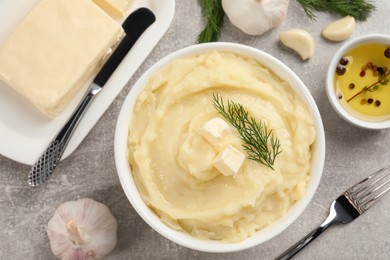 Photo of Delicious mashed potato with dill and butter served on light grey table, flat lay