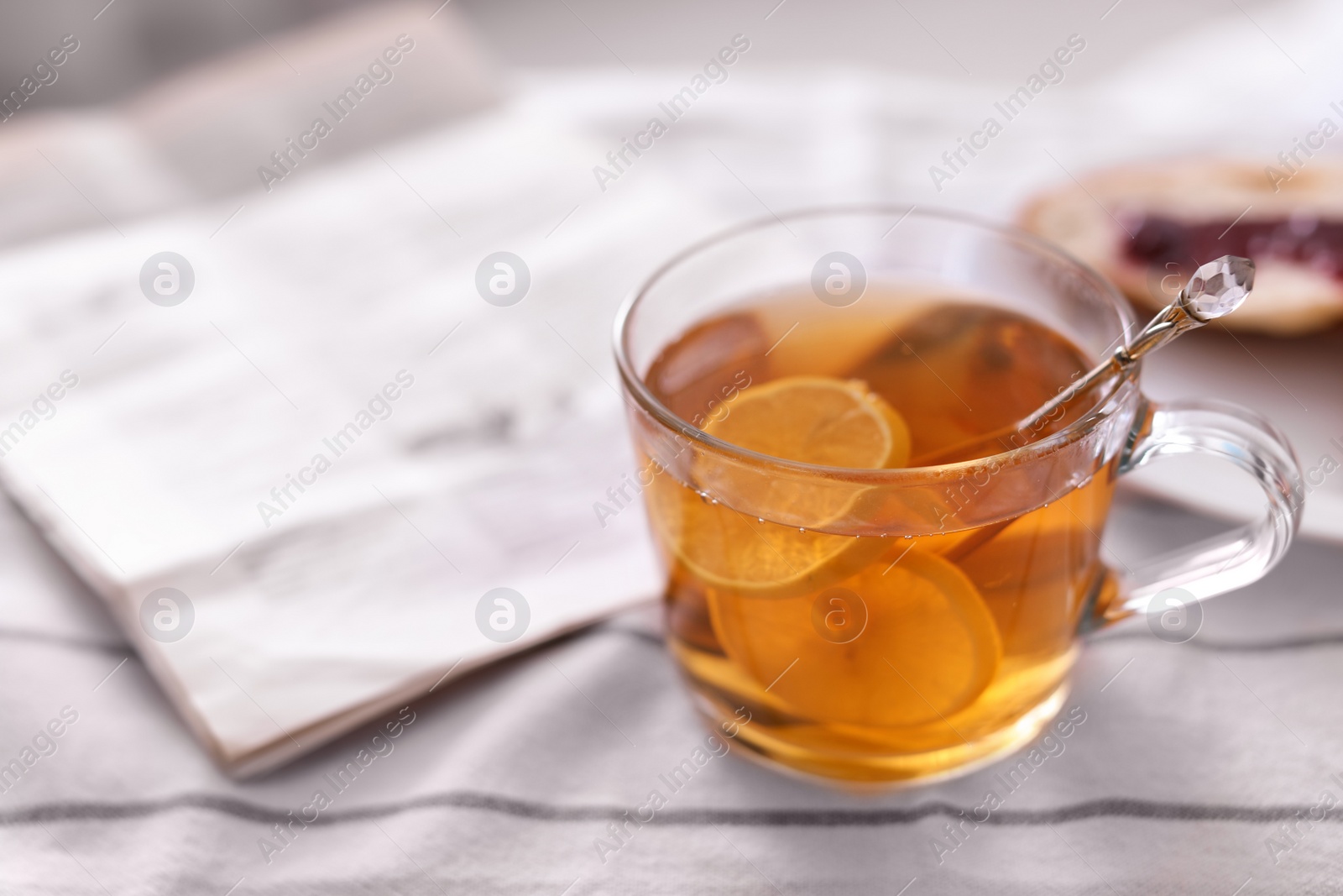 Photo of Morning tea and newspaper on fabric indoors