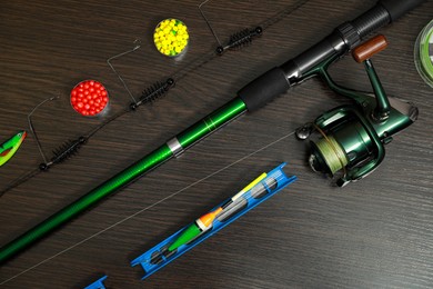 Fishing tackle on dark wooden background, flat lay