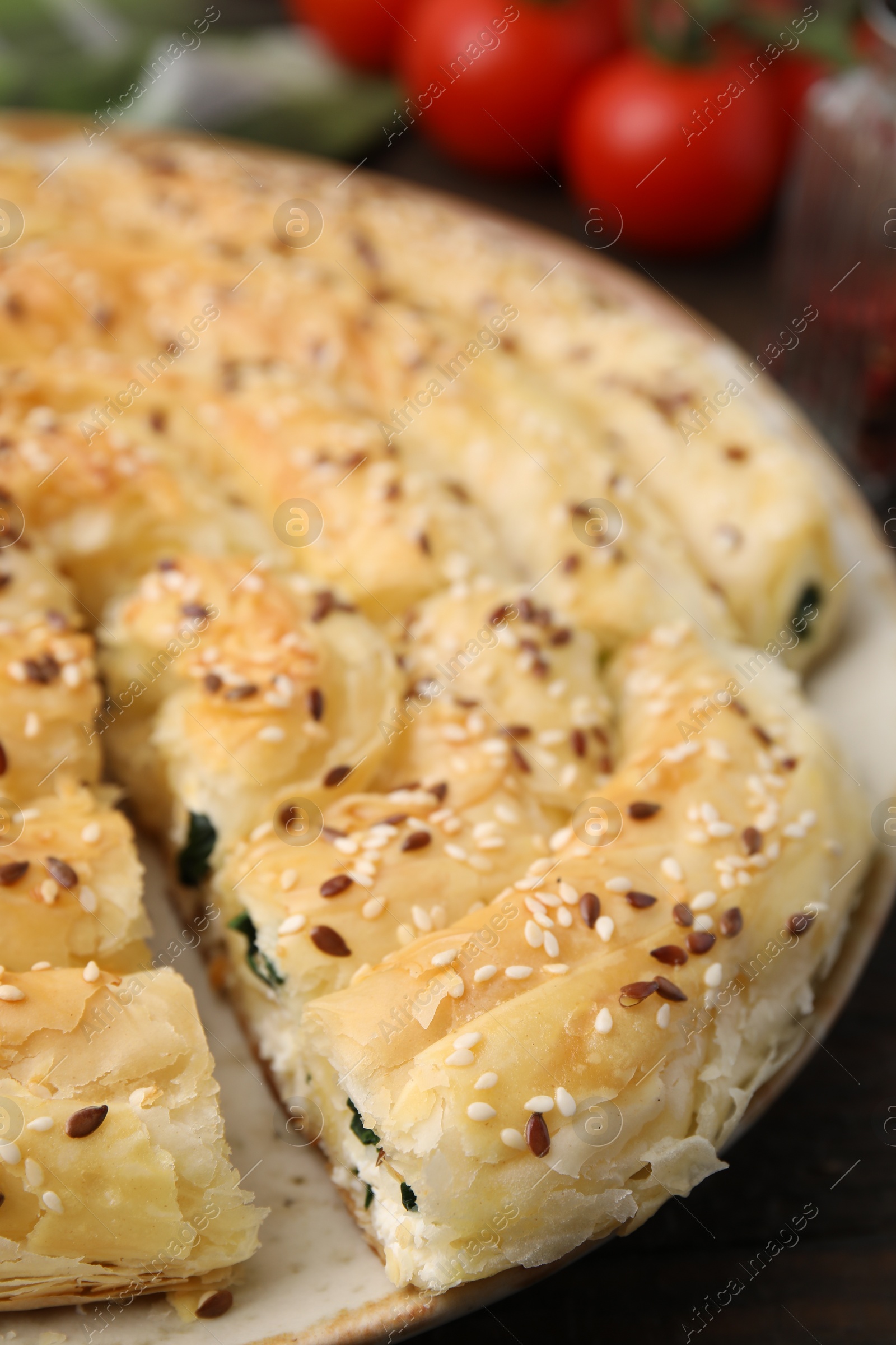 Photo of Delicious puff pastry with spinach on table, closeup