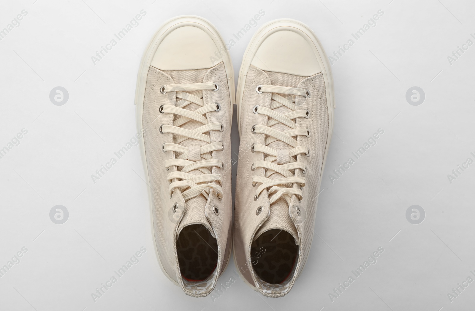 Photo of Pair of sneakers on white background, top view