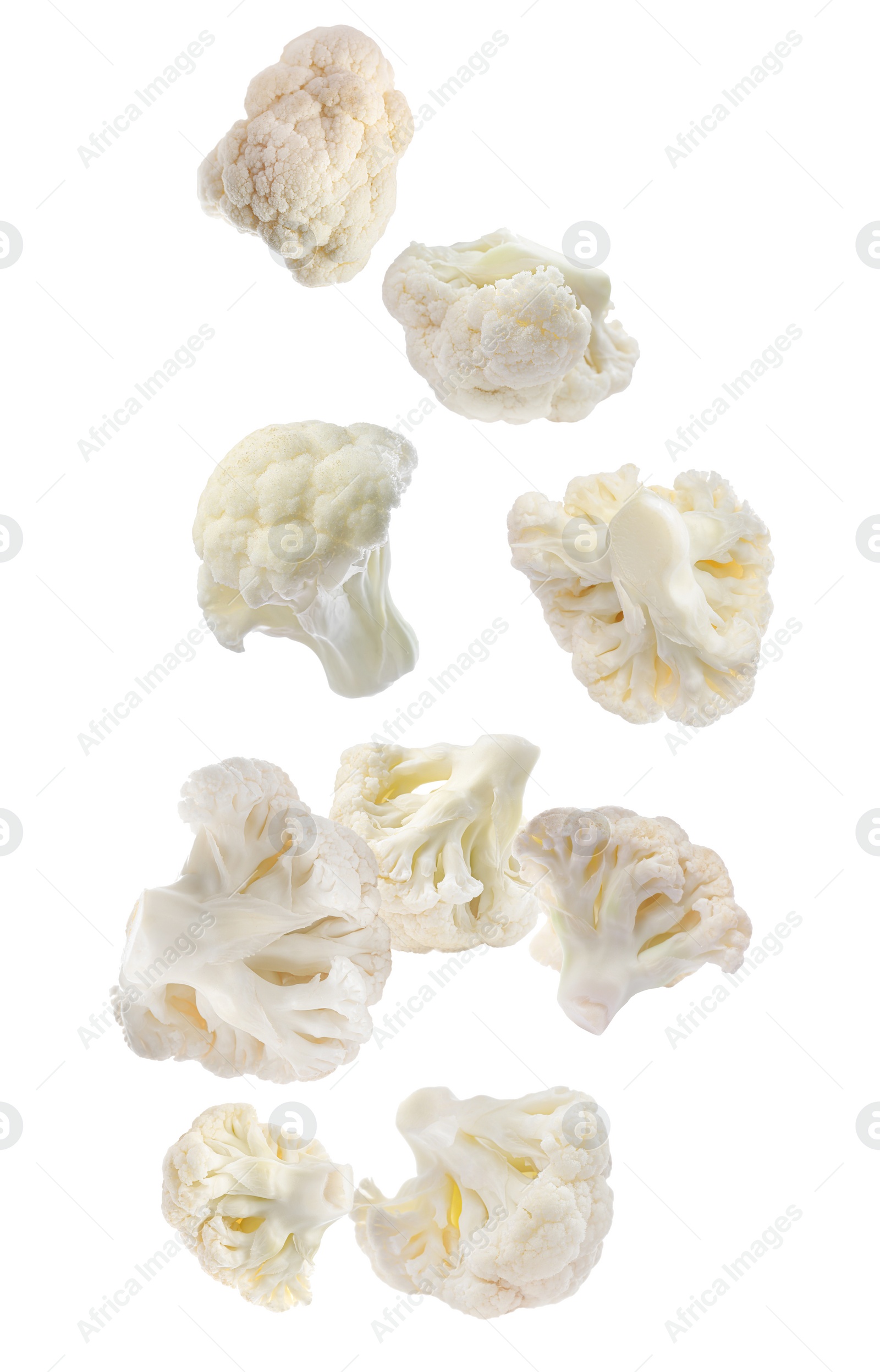 Image of Many fresh cauliflower florets falling on white background