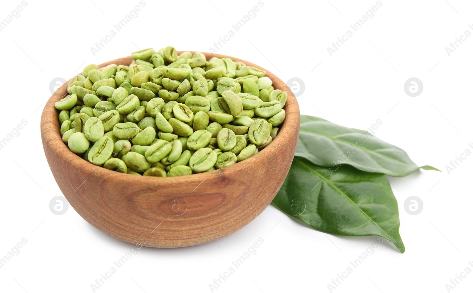 Photo of Wooden bowl with green coffee beans and fresh leaves on white background