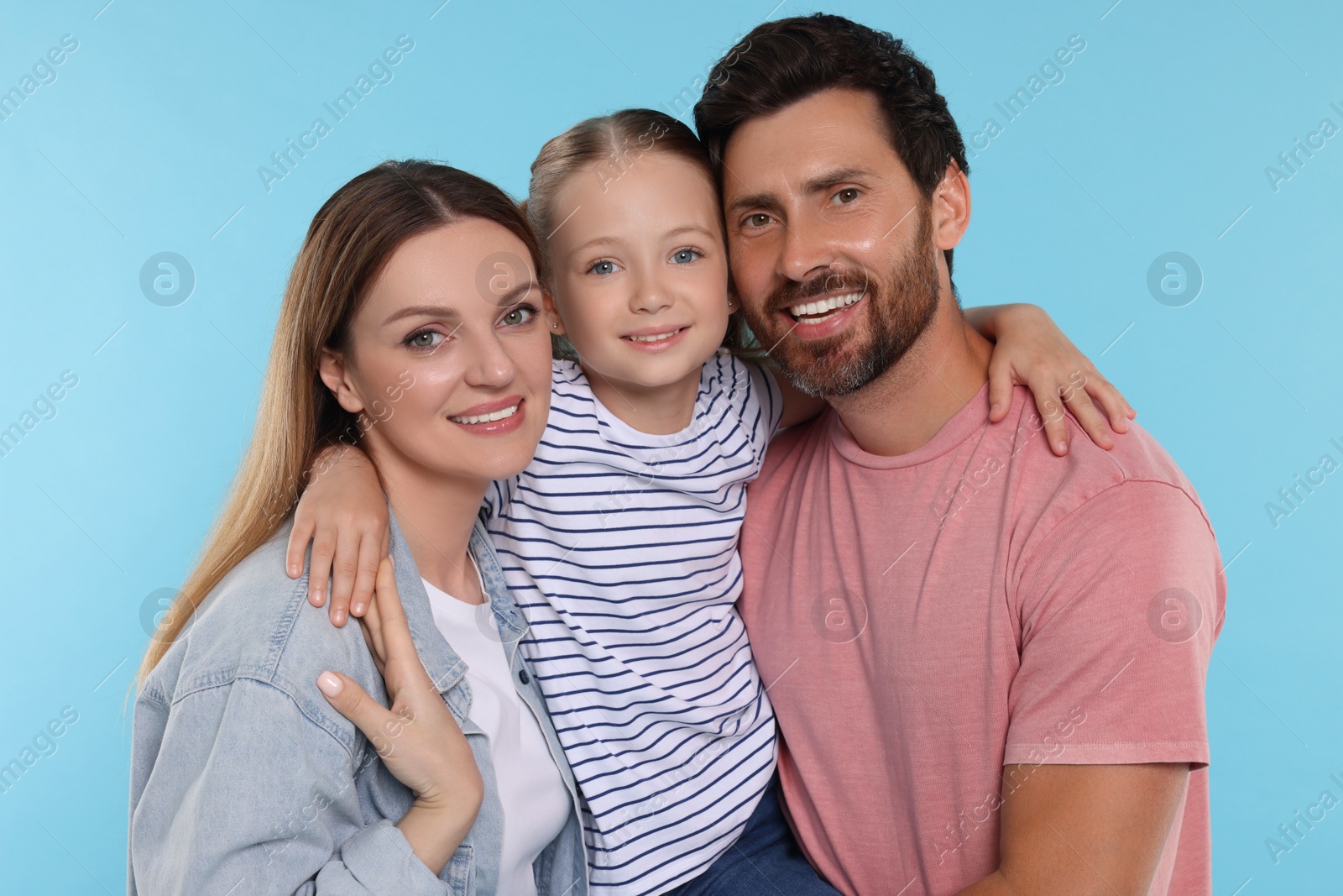 Photo of Happy family together on light blue background
