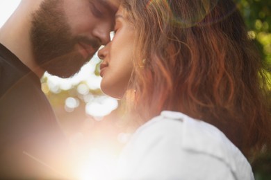 Photo of Happy young couple together in sunlight outdoors, closeup