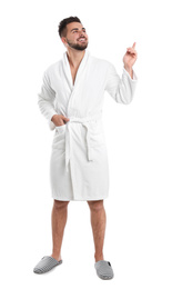 Handsome man wearing bathrobe on white background