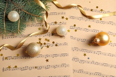 Photo of Flat lay composition with Christmas decorations on music sheets