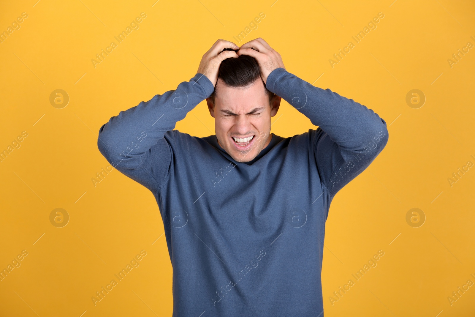 Photo of Portrait of stressed man on yellow background