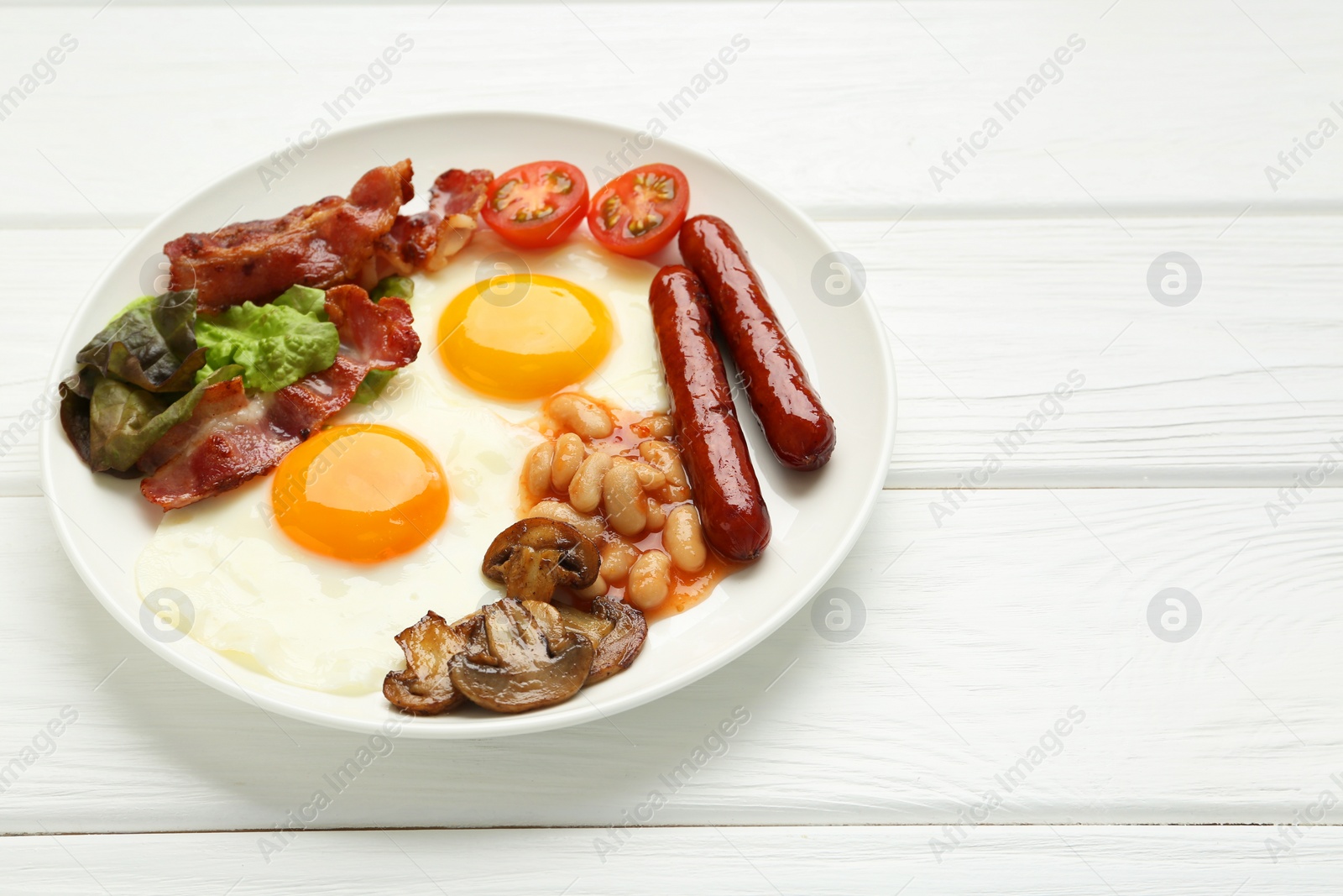 Photo of Delicious breakfast with sunny side up eggs on white wooden table