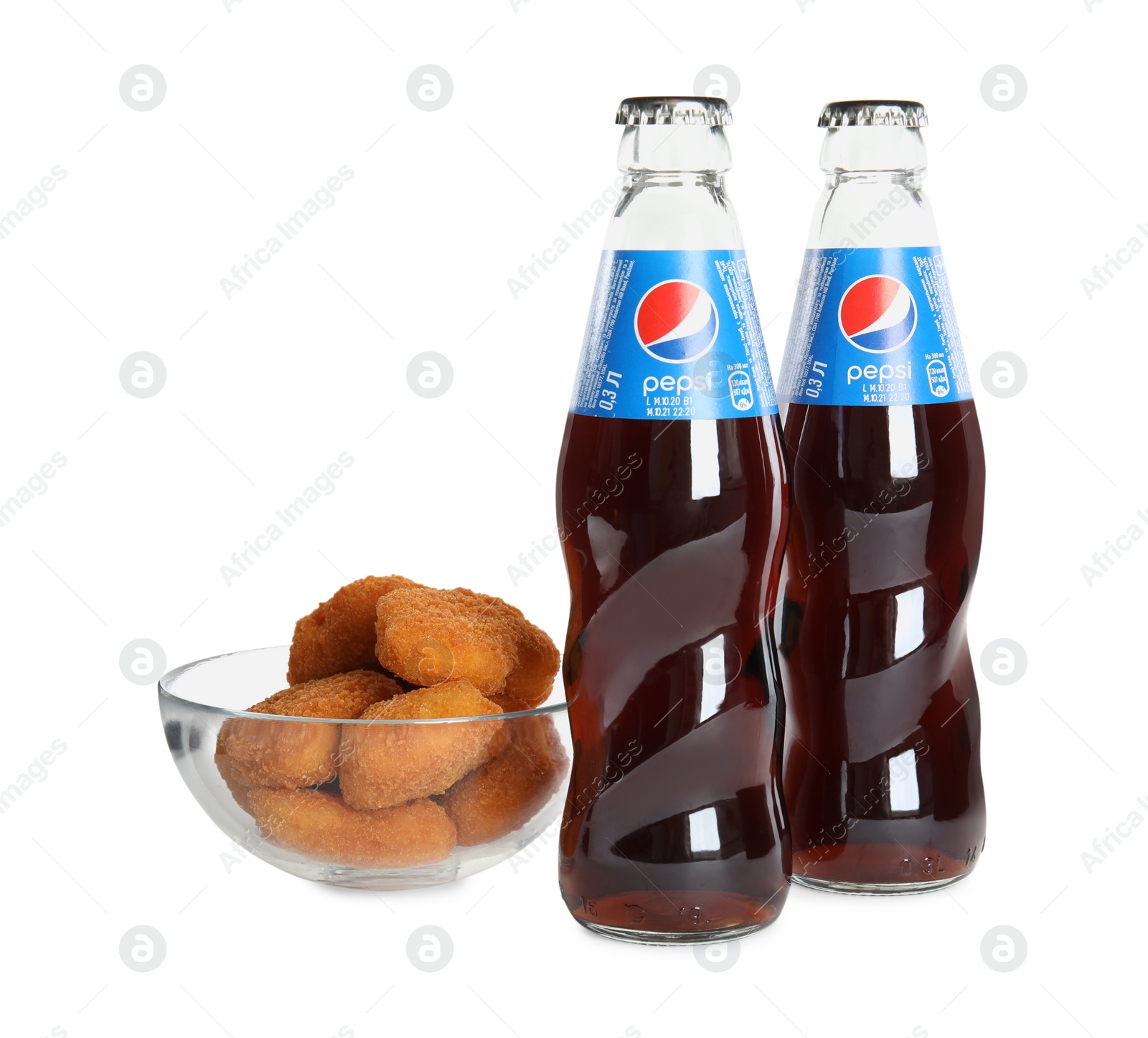 Photo of MYKOLAIV, UKRAINE - FEBRUARY 15, 2021: Glass bottles of Pepsi and snack on white background