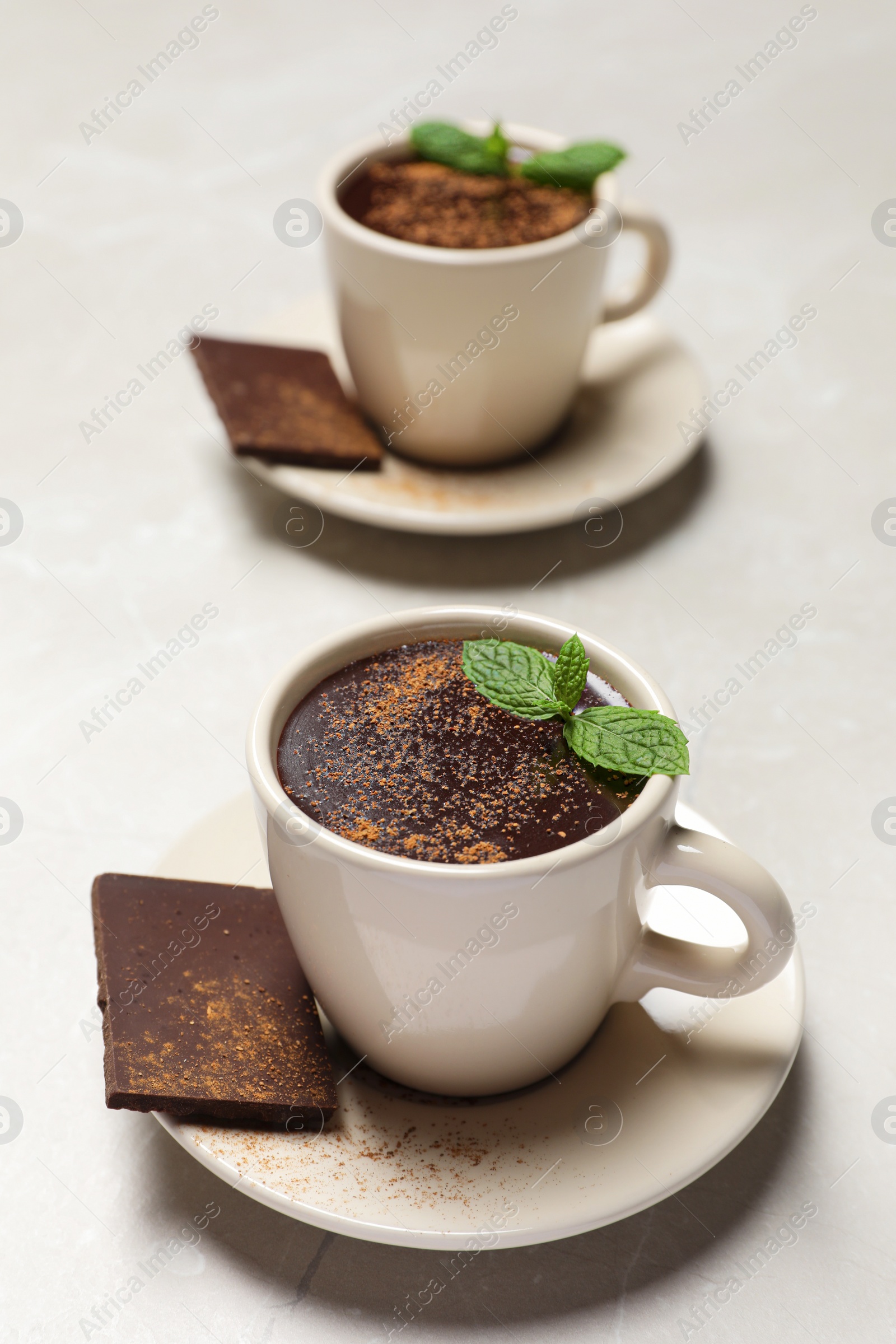 Photo of Cup of delicious hot chocolate with fresh mint on grey table