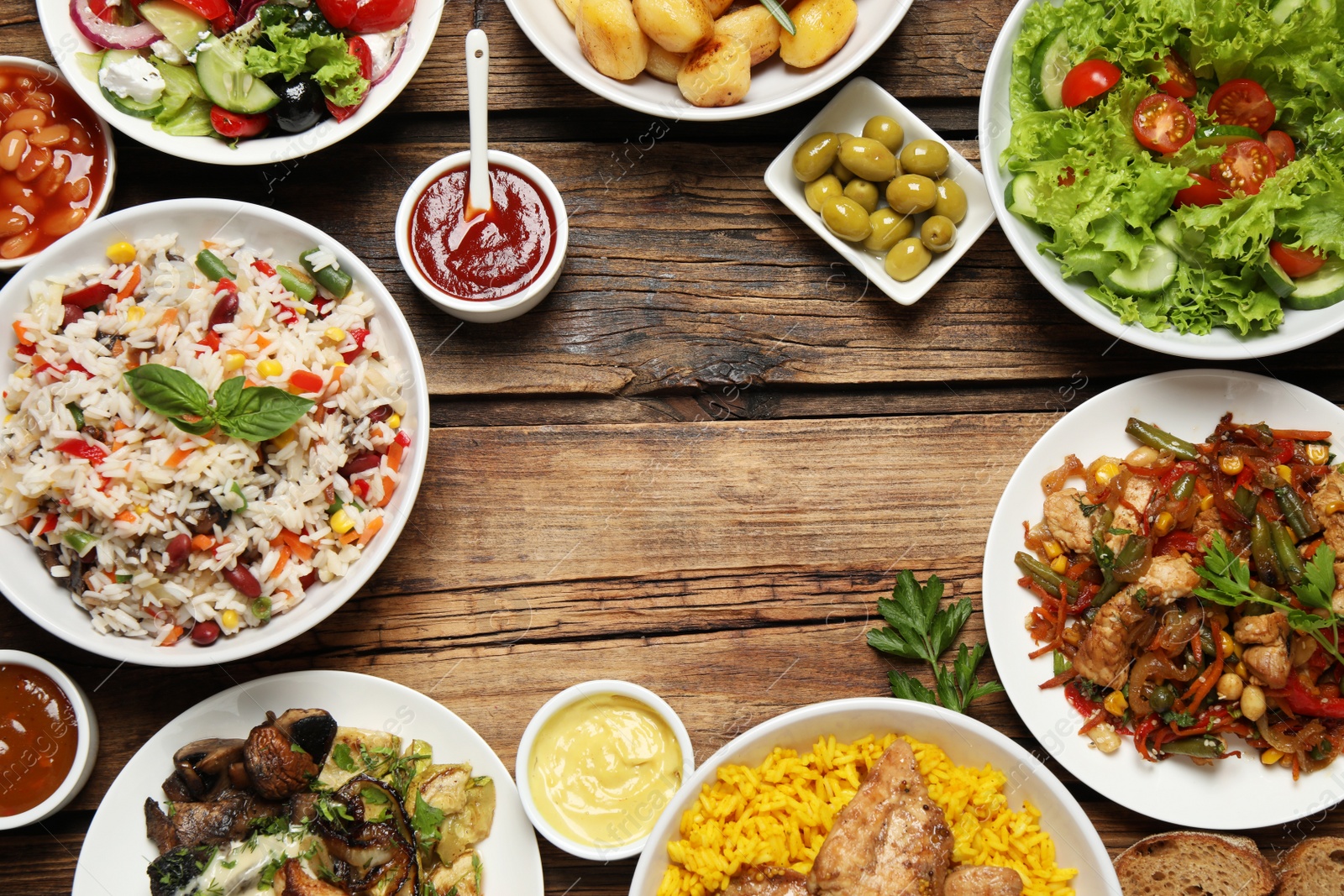 Photo of Buffet service. Frame of many  different dishes on wooden table, space for text