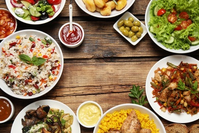 Photo of Buffet service. Frame of many  different dishes on wooden table, space for text