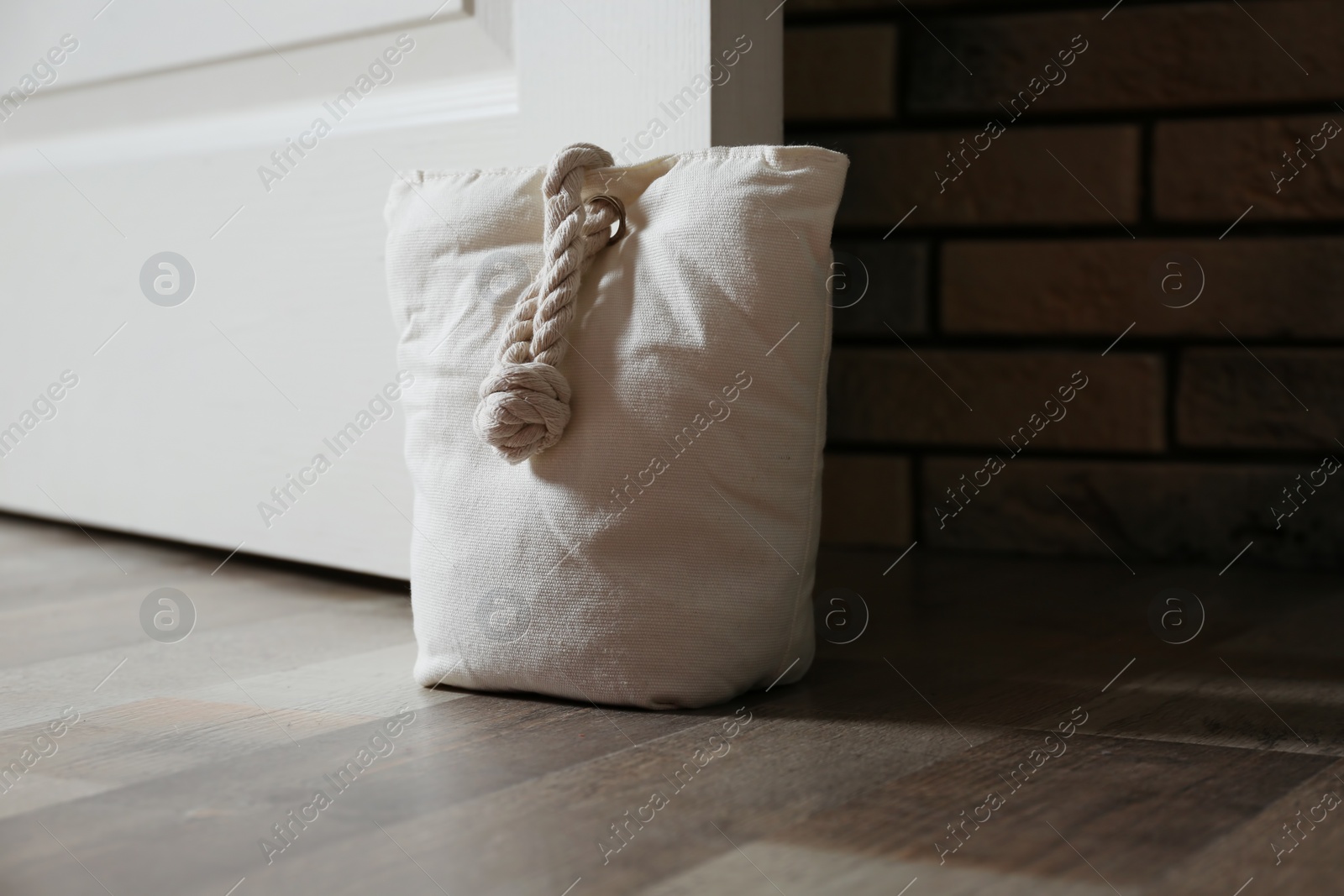 Stuffed bag holding wooden door at home Photo of Stuffed bag holding wooden door at home