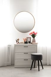 Stylish room interior with dressing table and mirror