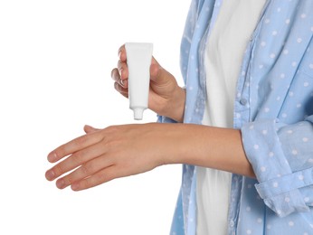 Woman applying cream on her hand against white background, closeup