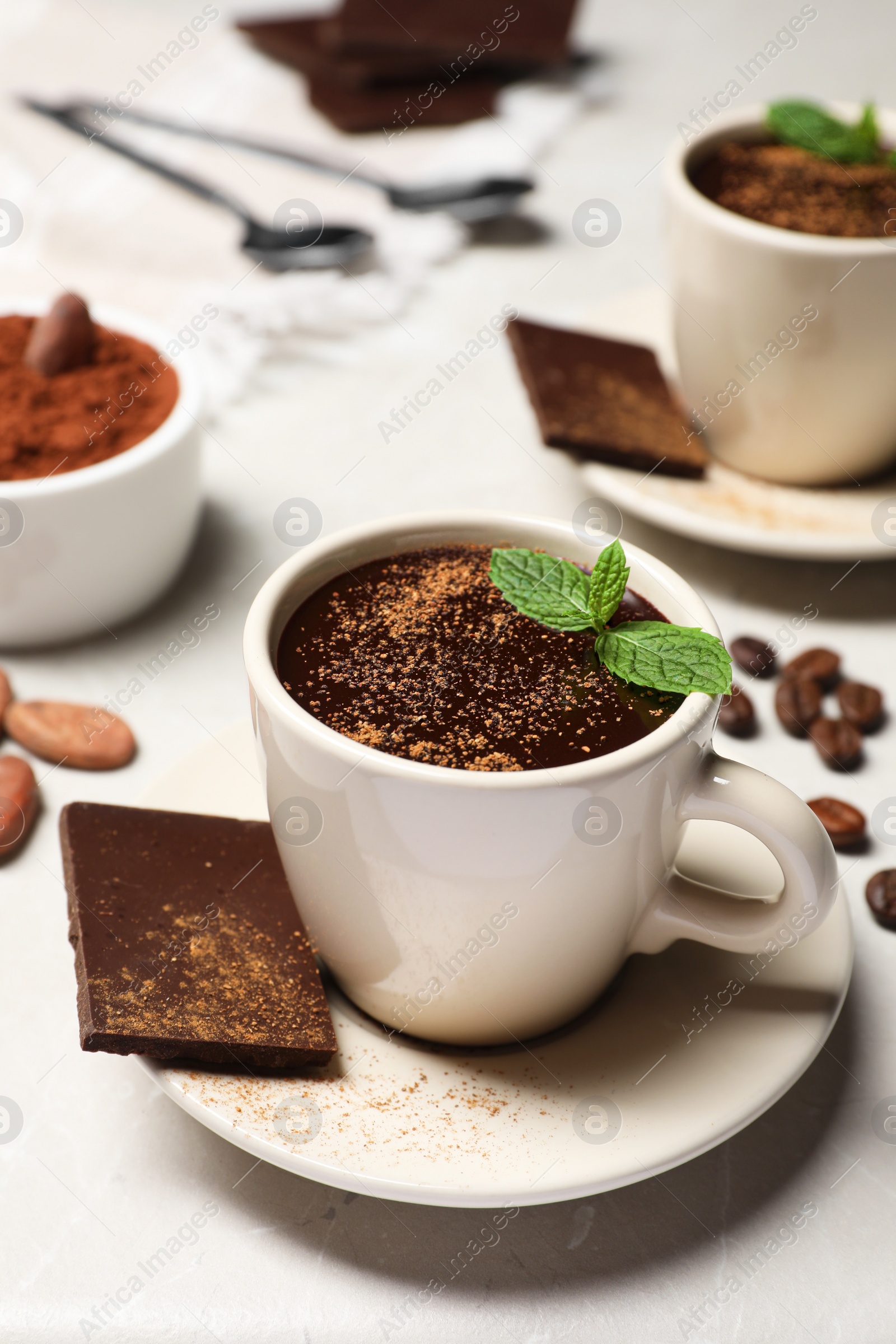 Photo of Delicious hot chocolate with fresh mint served on grey table