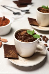 Delicious hot chocolate with fresh mint served on grey table