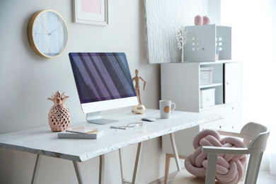 Contemporary workplace with computer on table near white wall. Interior design