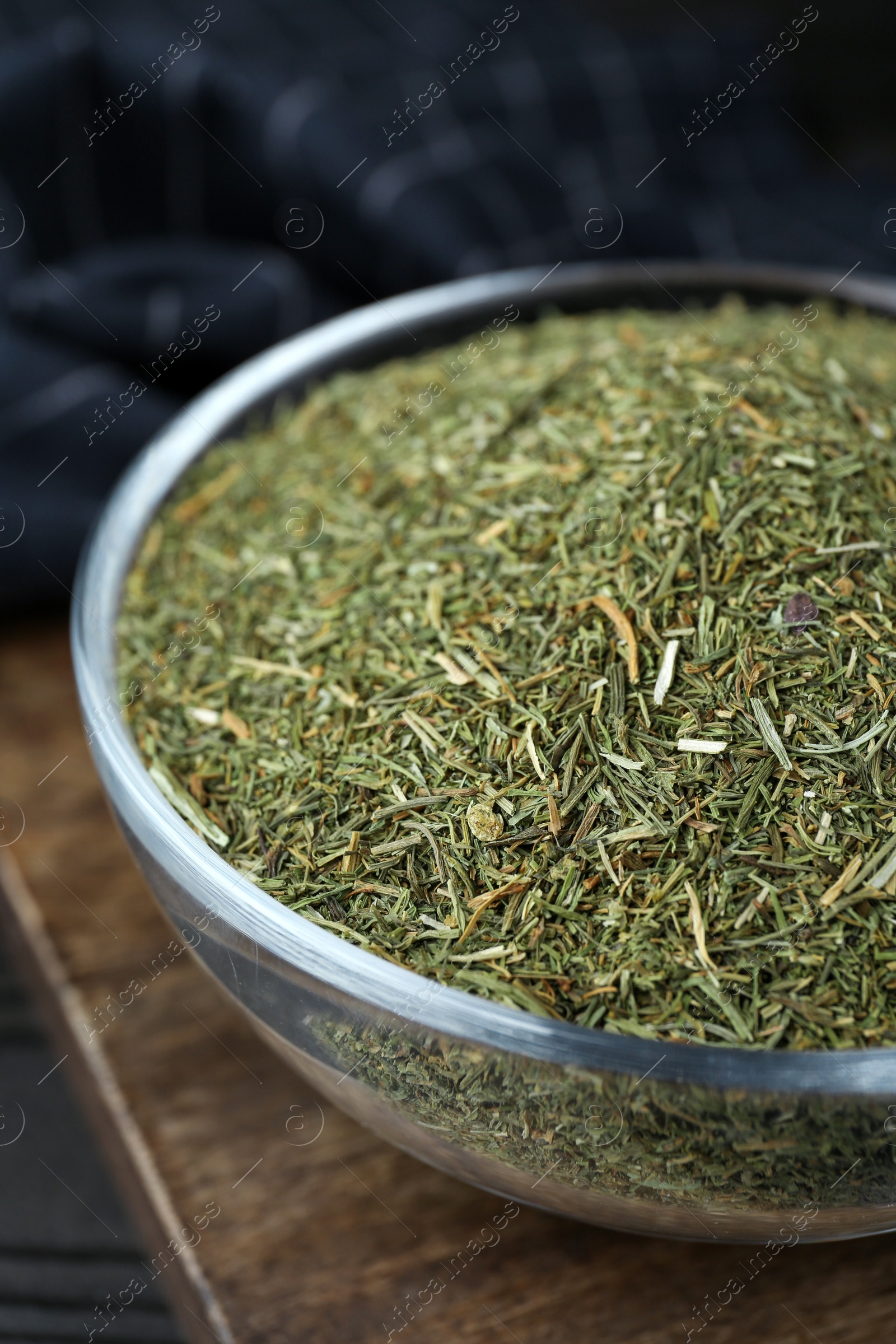 Photo of Glass bowl with dried dill on table, closeup