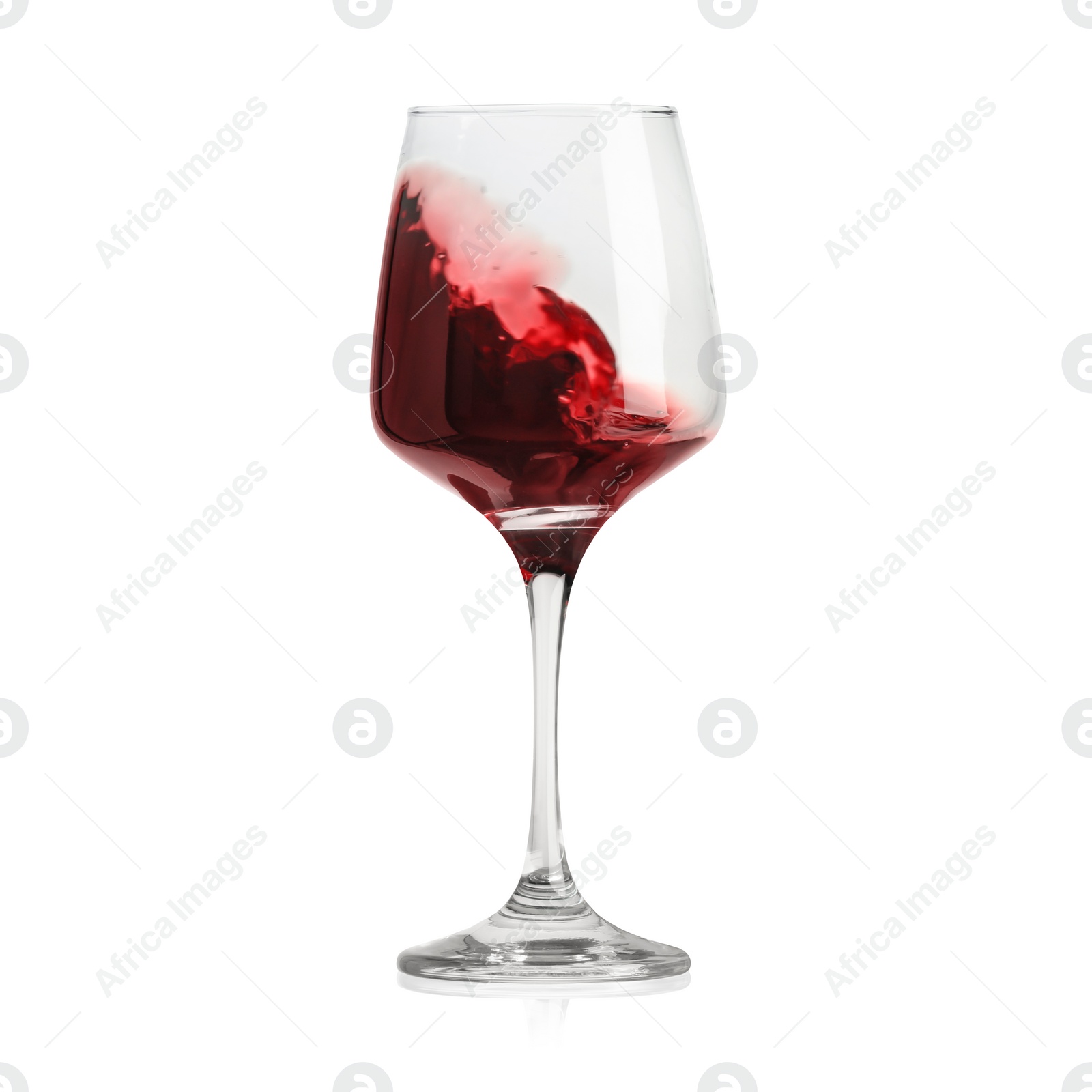 Image of Red wine splashing in glass on white background