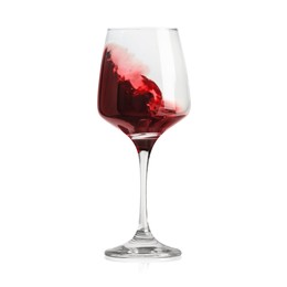 Red wine splashing in glass on white background