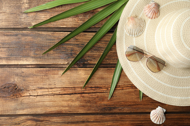 Flat lay composition with hat on wooden background. Beach objects