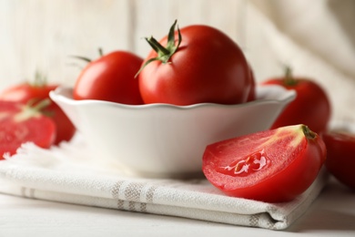 Fresh ripe tomatoes on white wooden table, closeup