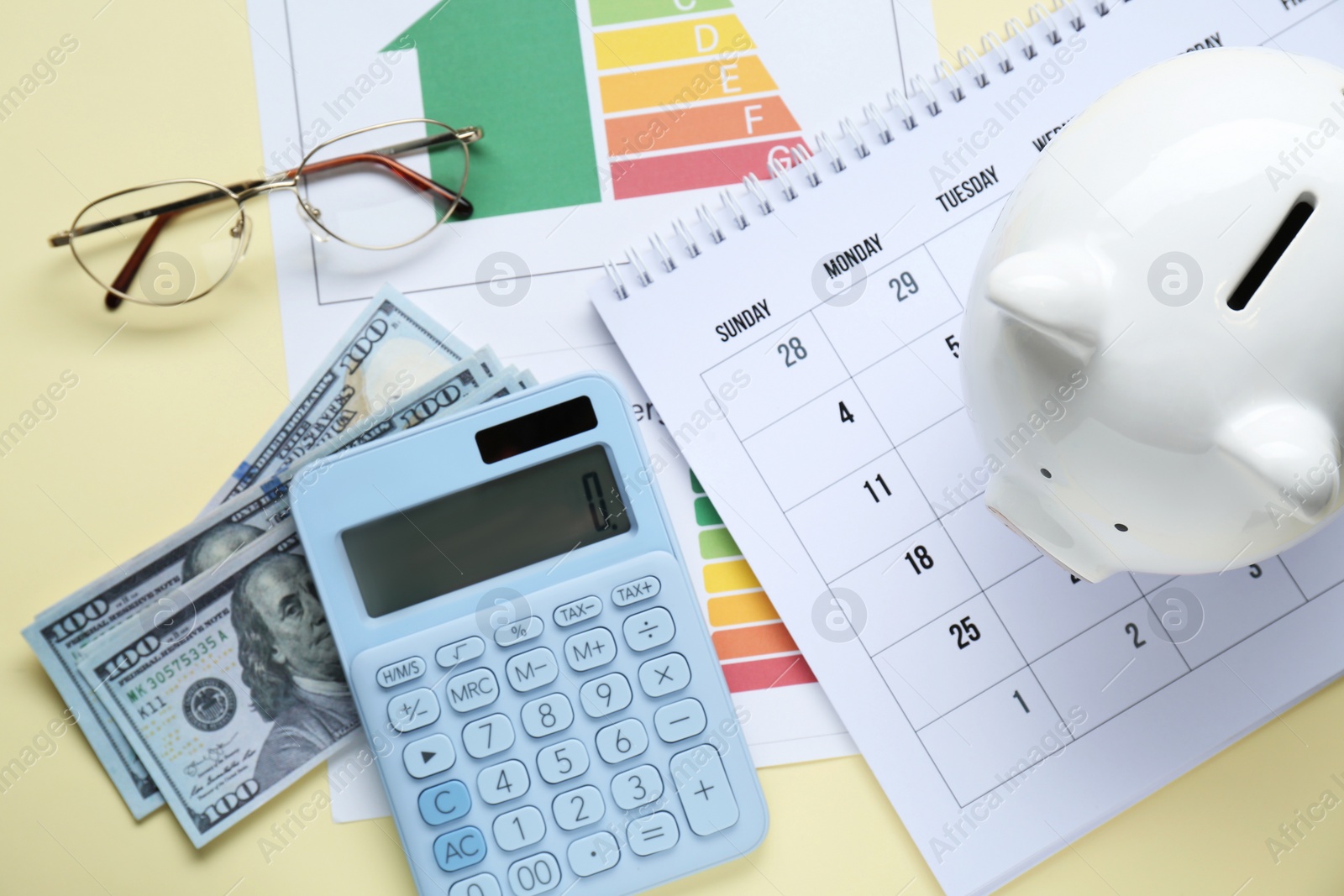 Photo of Flat lay composition with piggy bank and calculator on beige background