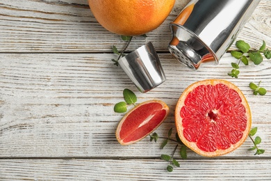 Photo of Flat lay composition with grapefruits and space for text on wooden background