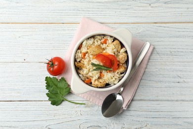 Photo of Delicious chicken risotto served on white wooden table, flat lay