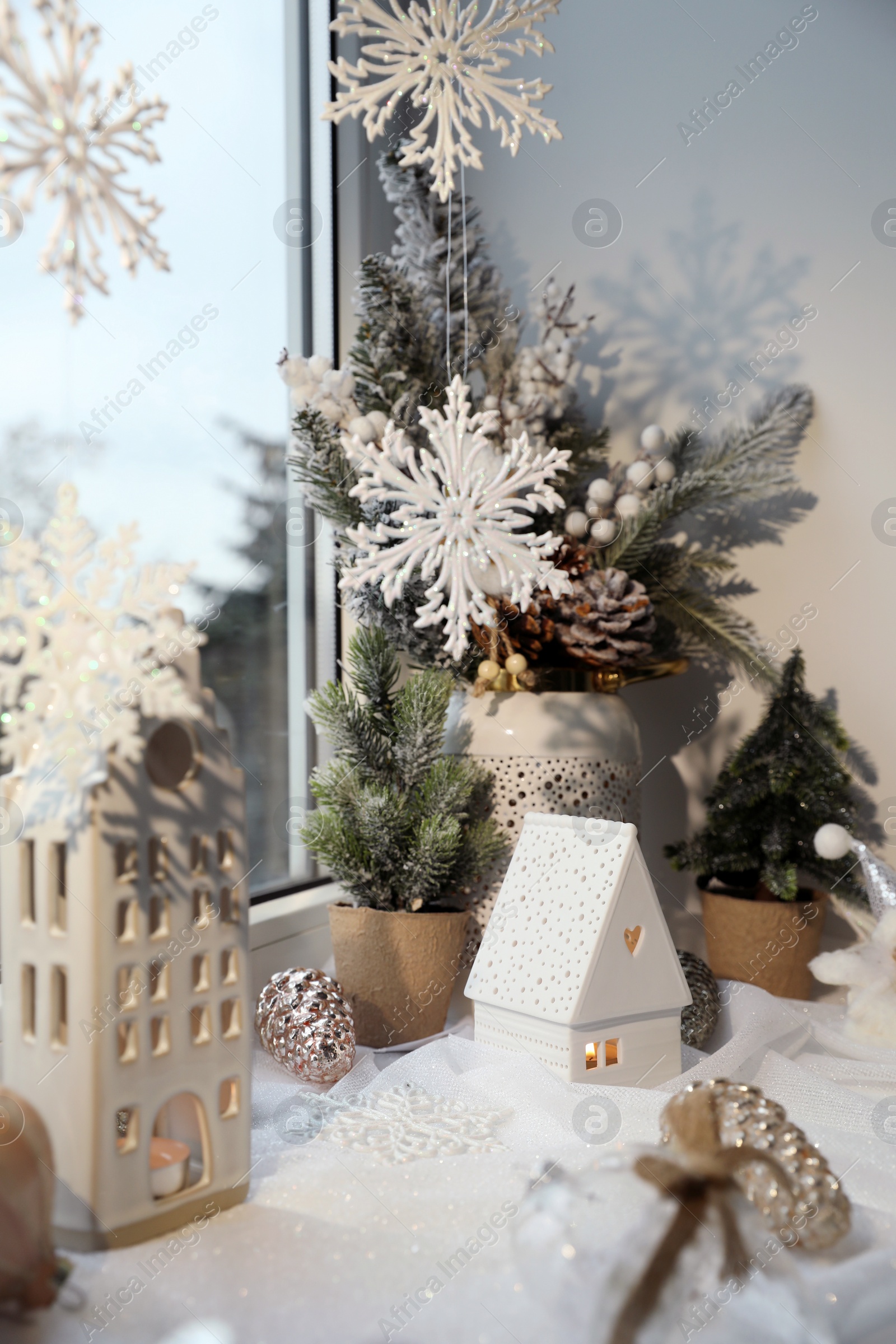 Photo of Many beautiful Christmas decorations and fir branches on window sill indoors