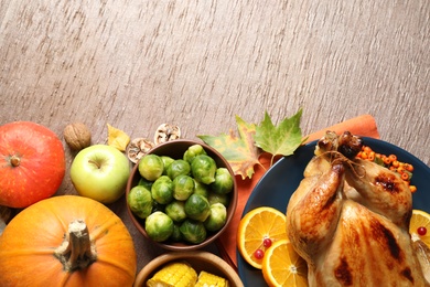 Flat lay composition with delicious turkey on wooden background, space for text. Happy Thanksgiving day