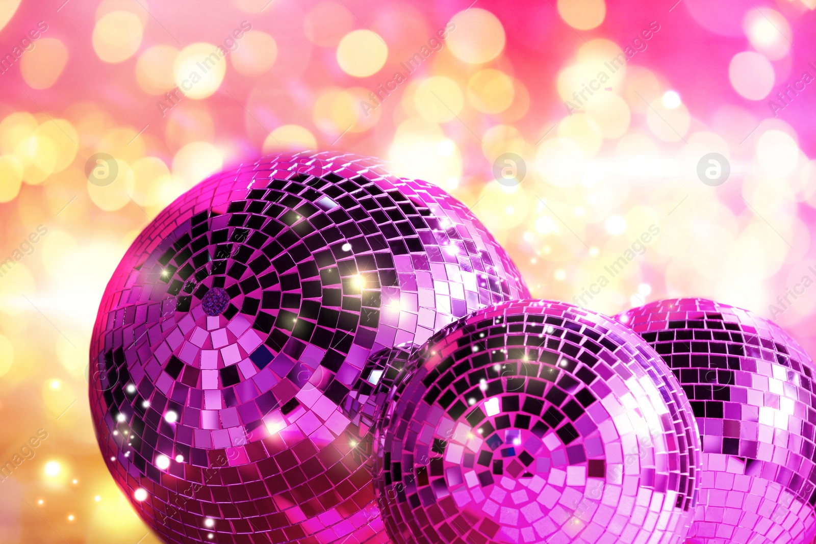 Image of Shiny disco balls against blurred lights, bokeh effect