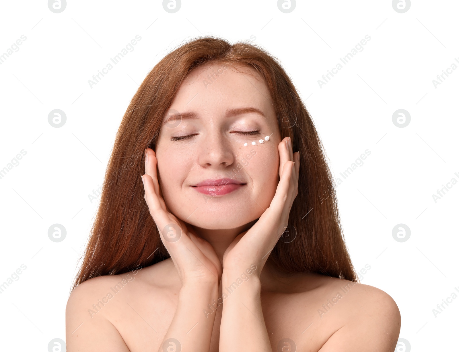 Photo of Beautiful woman with freckles and cream on her face against white background