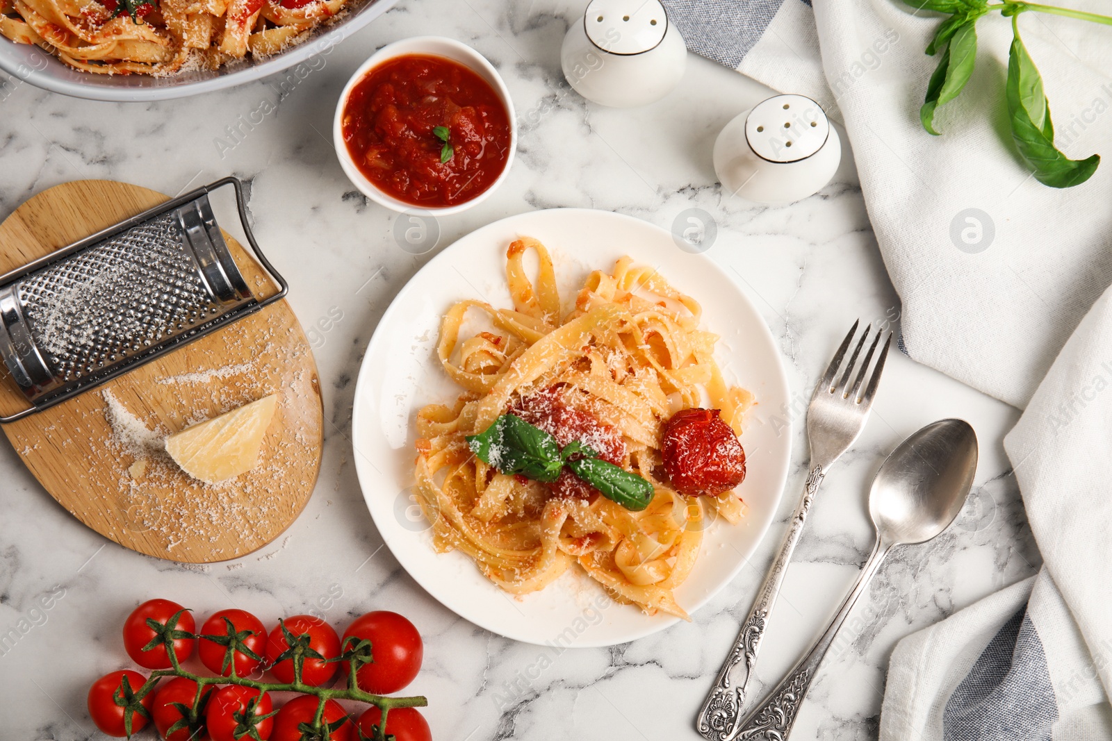 Photo of Flat lay composition with tasty pasta on white marble table