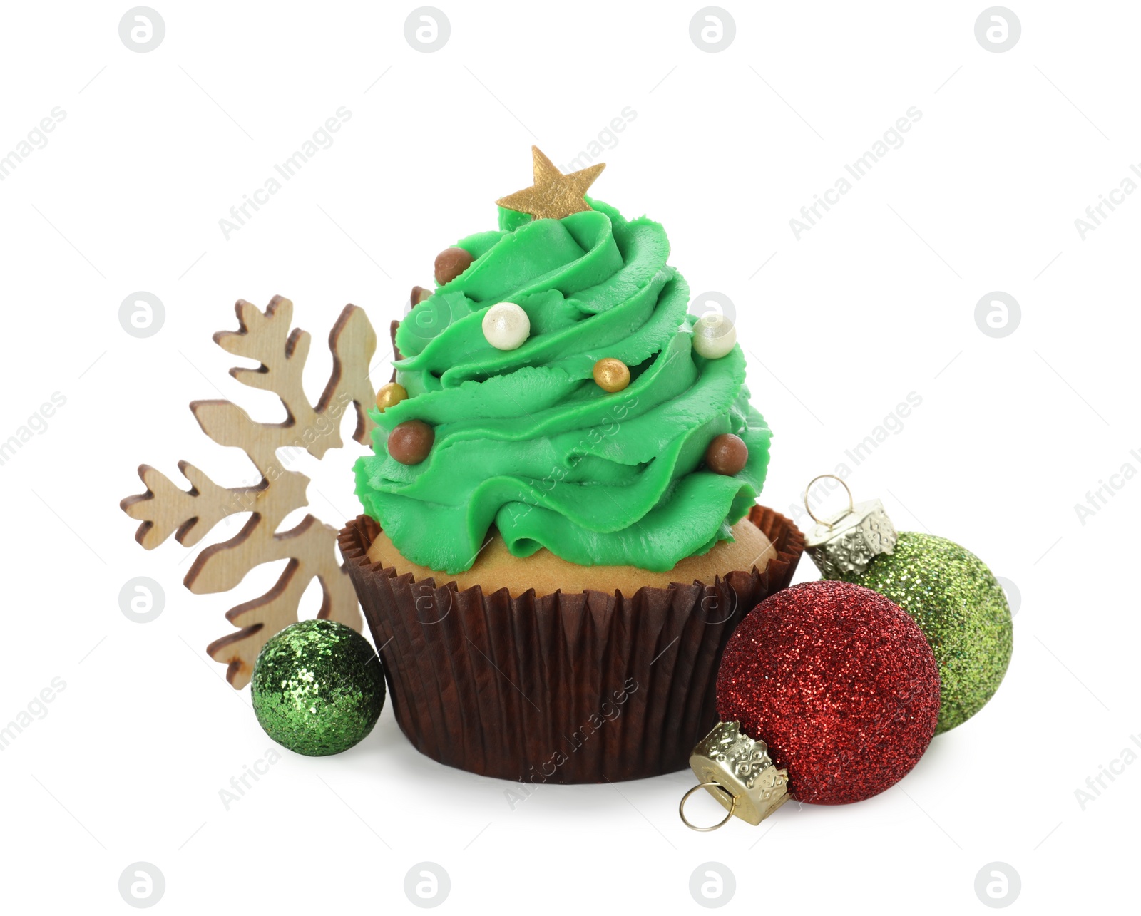 Photo of Tasty Christmas tree cupcake and festive decor on white background