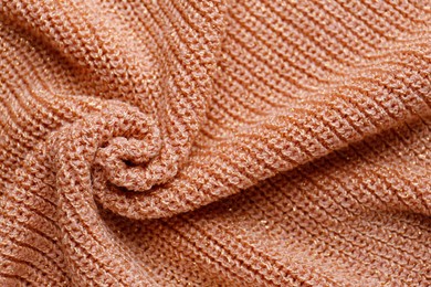 Photo of Brown knitted fabric as background, closeup view