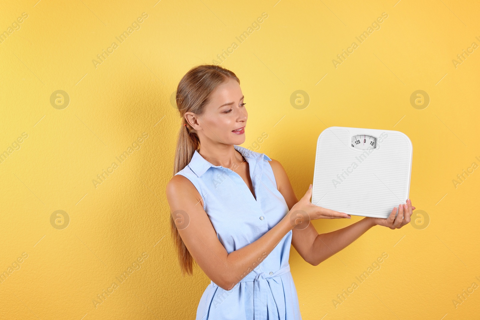 Photo of Slim woman with scale on color background. Healthy diet