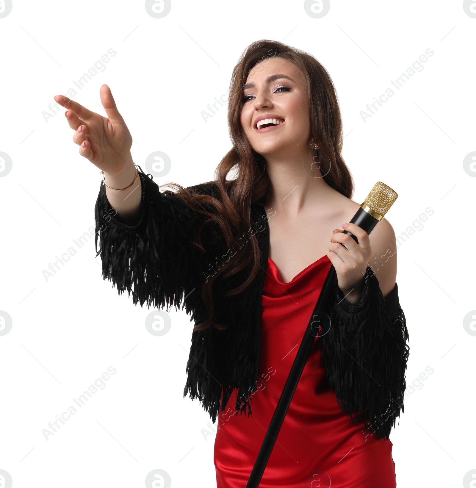 Photo of Beautiful young woman in stylish red dress with microphone singing on white background