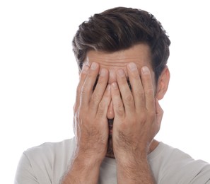 Photo of Embarrassed man covering face with hands on white background