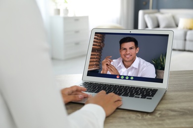 Image of Coworkers working together online. Woman using video chat on laptop, closeup