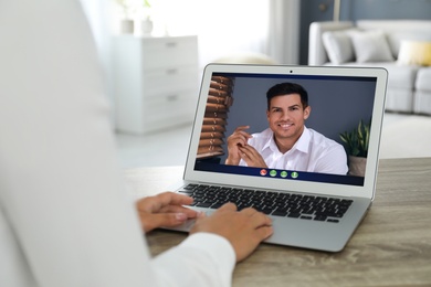 Coworkers working together online. Woman using video chat on laptop, closeup