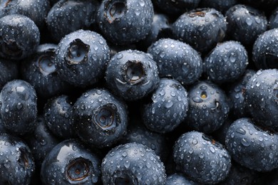 Photo of Wet fresh blueberries as background, top view