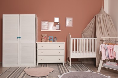 Photo of Baby room interior with stylish furniture and comfortable crib