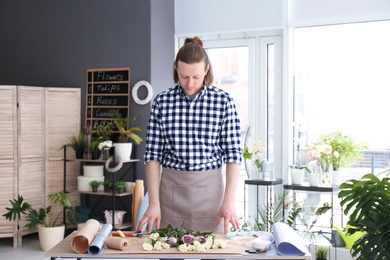 Photo of Handsome male florist at workplace