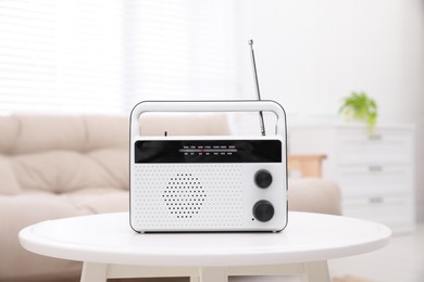 Photo of Stylish white radio on table in living room